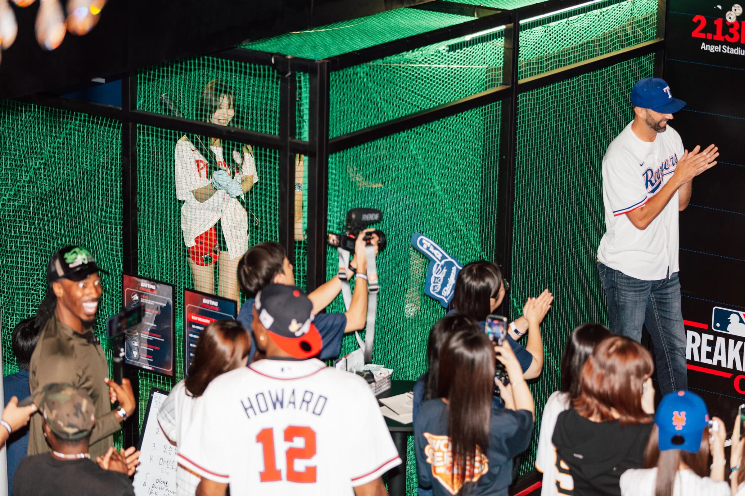 Guests gather around a baseball player at the MLB Breakfast Club.